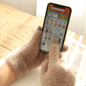 Detail of warm winter faux mink fur gloves with conductive touch screen fingertips