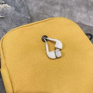 Japanese style yellow canvas crossbody bag with reinforced metal headphone port detail
