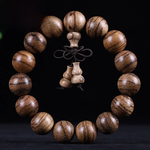Macro shot of 15mm agarwood beads with a gourd pendant and dark brown Chinese knot