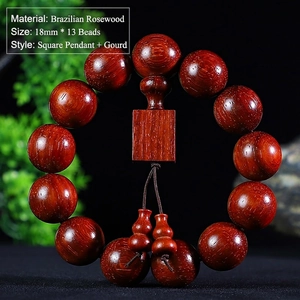 Detailed macro view of Brazilian rosewood beads with carved square pendant and gourds