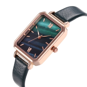 Detail of square quartz watch with vintage green gradient dial and leather strap