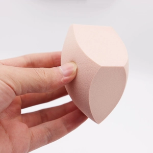 Pink slanted egg-shaped makeup sponge puff for smooth foundation application