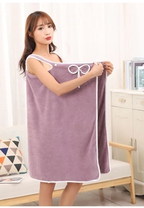 Detail of purple coral fleece wearable bath towel with a white bow and soft texture