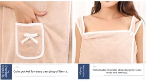 Detail of coral fleece wearable bath towel showing bow pocket and button strap