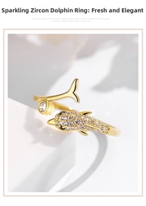Macro detail of 18k gold-plated dolphin ring with cubic zirconia paving and open band