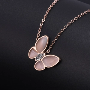 Rose gold butterfly necklace with pink cat eye stone and zircon on black background