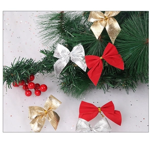 Close-up of red, gold, and silver Christmas bows with festive pine and berry accents