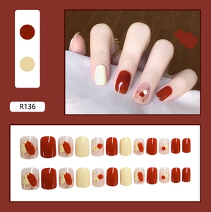 Detail view of R136 glossy press-on nails with red and white polka dot design