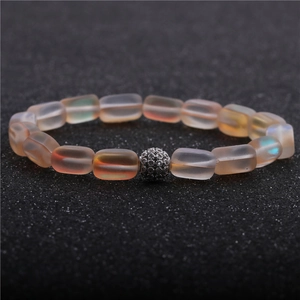 Macro shot of moonstone bead bracelet with a crystal-encrusted pave ball focal piece