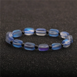Elegant moonstone copper bead bracelet with blue gradient barrel beads on black textured base