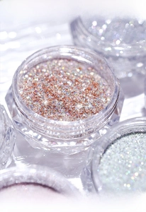 Macro shot of fine sparkling nail powder in a crystal jar for shiny manicure art