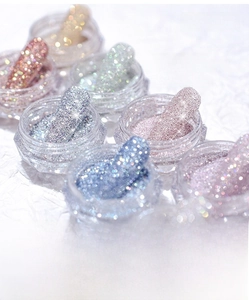 Macro view of sparkly crystal diamond powder jars for 3D relief nail art decoration