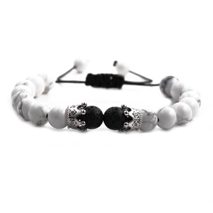 Detailed shot of white turquoise beads with silver crown charms and adjustable cord