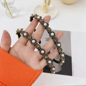 Detailed macro view of baroque headband with pearls and rhinestones on alloy frame