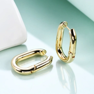 Macro shot of 18K gold plated U-shaped oval hoop earrings showing high gloss finish