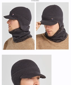 Detail of dark grey knit winter hat with visor and matching warm fleece neck gaiter