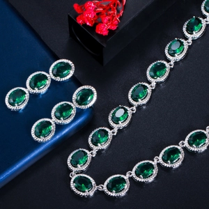 Elegant silver jewelry set with oval emerald green stones including necklace and earrings