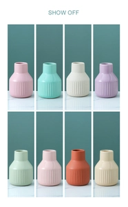 Minimalist ceramic vases with vertical texture in various pastel colors on marble