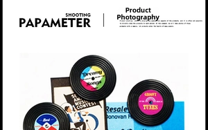 Retro vinyl record fridge magnets with vintage labels on artistic newspaper background