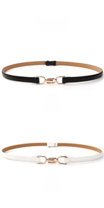 Detail of slim black and white leather belts featuring a golden U-shaped metal buckle