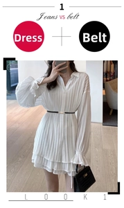 Detail view of white pleated V-neck dress with black slim belt for elegant styling