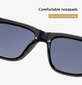 Macro shot of comfortable integrated nose pads on glossy black fashion sunglasses