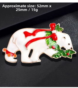 Macro view of Christmas polar bear brooch with enamel finish and red bow tie details
