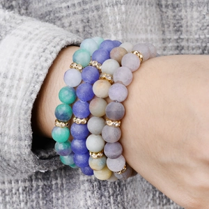 Natural stone bead bracelet set with matte texture and gold rhinestone spacers on wrist