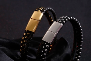 Close-up of double-layer braided leather bracelets with gold and silver magnetic clasps