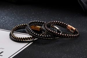 Detail of woven black leather bracelets with gold, silver and rose gold magnetic clasps