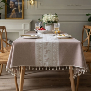Linen style rectangle tablecloth with festive reindeer pattern and tassel fringe edges