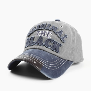 Detail der Vintage-Baseballkappe aus gewaschenem Denim mit BLACK-Stickerei und Schirm