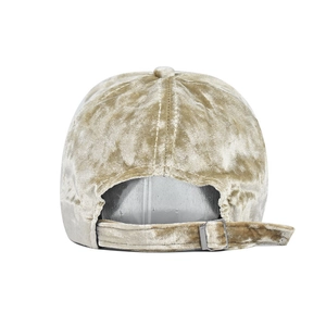 Detail view of gold velvet baseball cap featuring adjustable strap and silver metal buckle