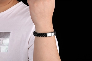 Detail of men's woven leather bracelet with silver steel wire and magnetic clasp