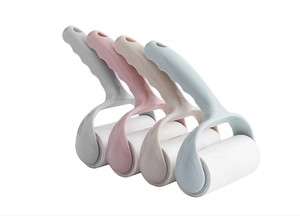 Detailed view of handheld lint rollers in pastel blue, pink, beige and light grey