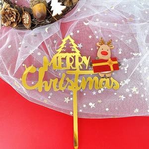 Golden acrylic Merry Christmas cake topper with reindeer and tree on red festive background