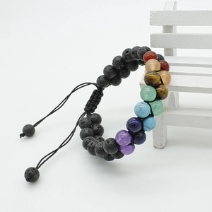 Macro detail of double-layer lava rock chakra stone bracelet with adjustable braided rope