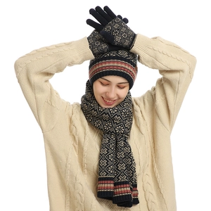Winter knitted navy blue set including snowflake pattern hat, scarf, and gloves
