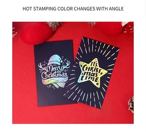 Detail of laser gold stamping on navy Christmas cards with festive motifs and ornaments