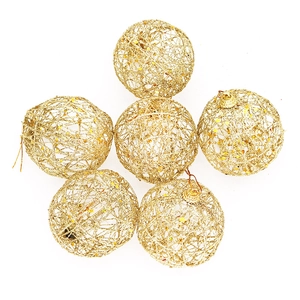 Close-up of six gold hollowed-out Christmas balls with sparkling glitter finish