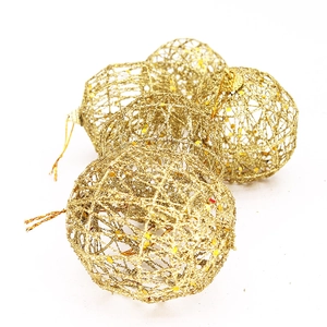 Detailed view of five hollow golden glitter Christmas tree wire ornaments with hanging strings