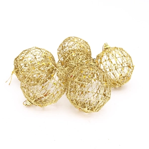Detailed view of five hollow gold Christmas ornaments with sparkling glitter texture