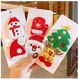 Close-up of 6-piece Christmas plush hair clip set with snowman and reindeer designs