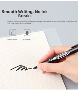 Close-up of hand writing with a black dual-tip oil-based permanent CD marker on paper