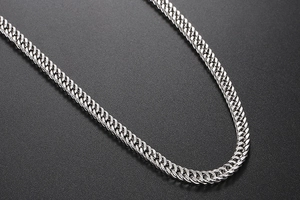Detailed close-up of a silver braided titanium steel bracelet with polished metallic finish