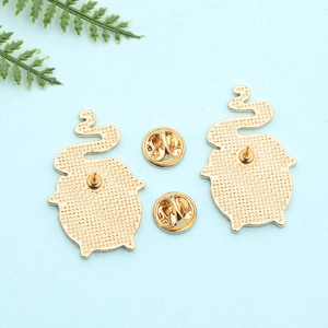 Back view of cartoon animal enamel pins showing gold metal texture and butterfly clutches