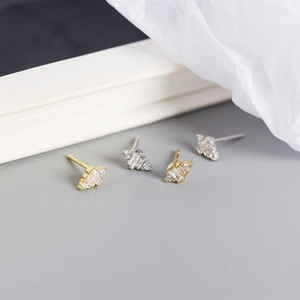 Macro detail of gold and silver S925 sterling silver earrings with square-cut cubic zirconia