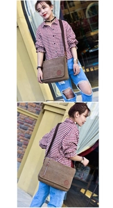 Men's vintage brown canvas messenger bag with adjustable strap in outdoor street setting