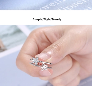 Detail of silver double-layered ring featuring pavé zircon and hollow floral elements