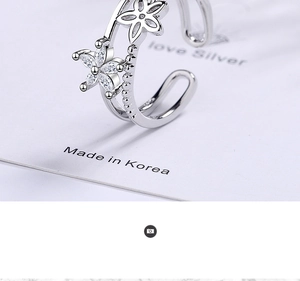 Detailed close-up of double-layer open ring with hollow and zircon-set flowers